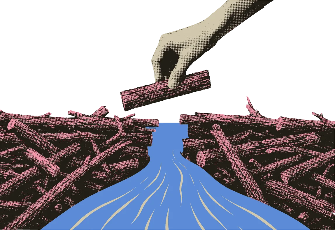 A hand lifting a log from a jam